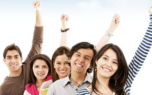 Picture of five students smiling with their left arms held up in the air.