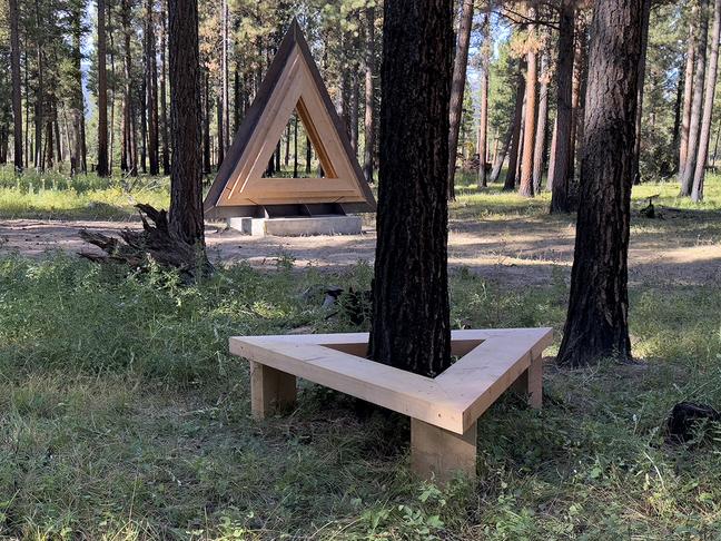 Triangular sculpture made from fabricated steel and wood at Sculpture in the Wild