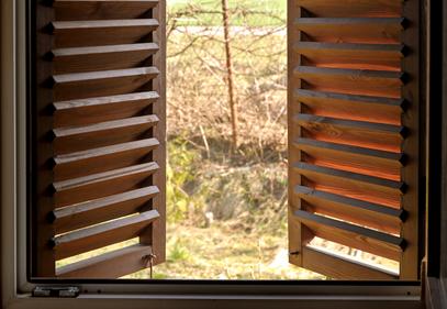 open wood shutters showing the beautiful nature outside