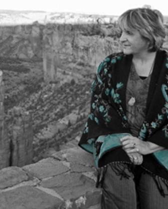 Patricia Grady Cox at Canyon de Chelly, Arizona. Spider Woman monolith. Photo by Susie Whiting