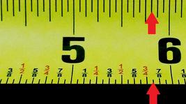 Measuring tape with arrow pointing to five and thirteen sixteenths