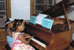 Young girls playing piano duet