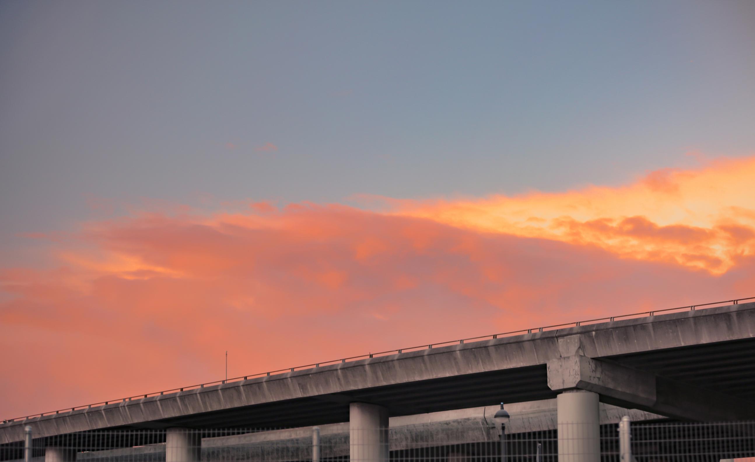 colorful clouds in sky with freeway city landscape