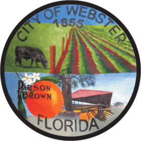 Circular logo for the city of Webster with pastures, a cow, an orange, and a building.