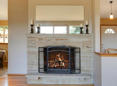 Photo of fireplace with custom frameless mirror