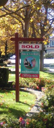 Yard with Real Estate Sign with Sold Rider