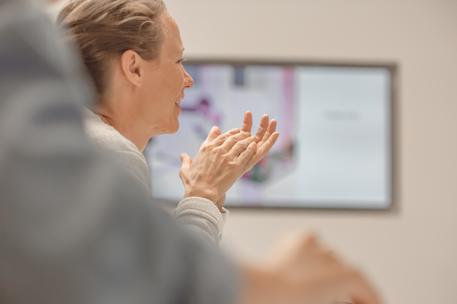 woman clapping after presentation screen background
