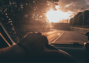 driving on a road with sunset