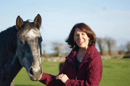 Rose Foley standing with a lovely horse on a nice day