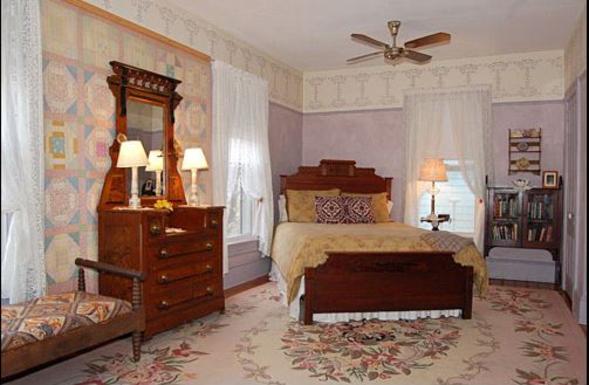 Wedgwood Accommodations - Image of the Lavendar Room with antique bed, dresser, bench, stenciled walls, lace curtains