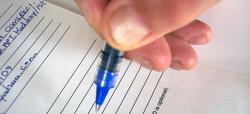 picture of someone filling out forms