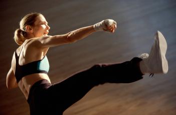 Fitness teacher performing a Kick boxing class for weight loss and body conditioning