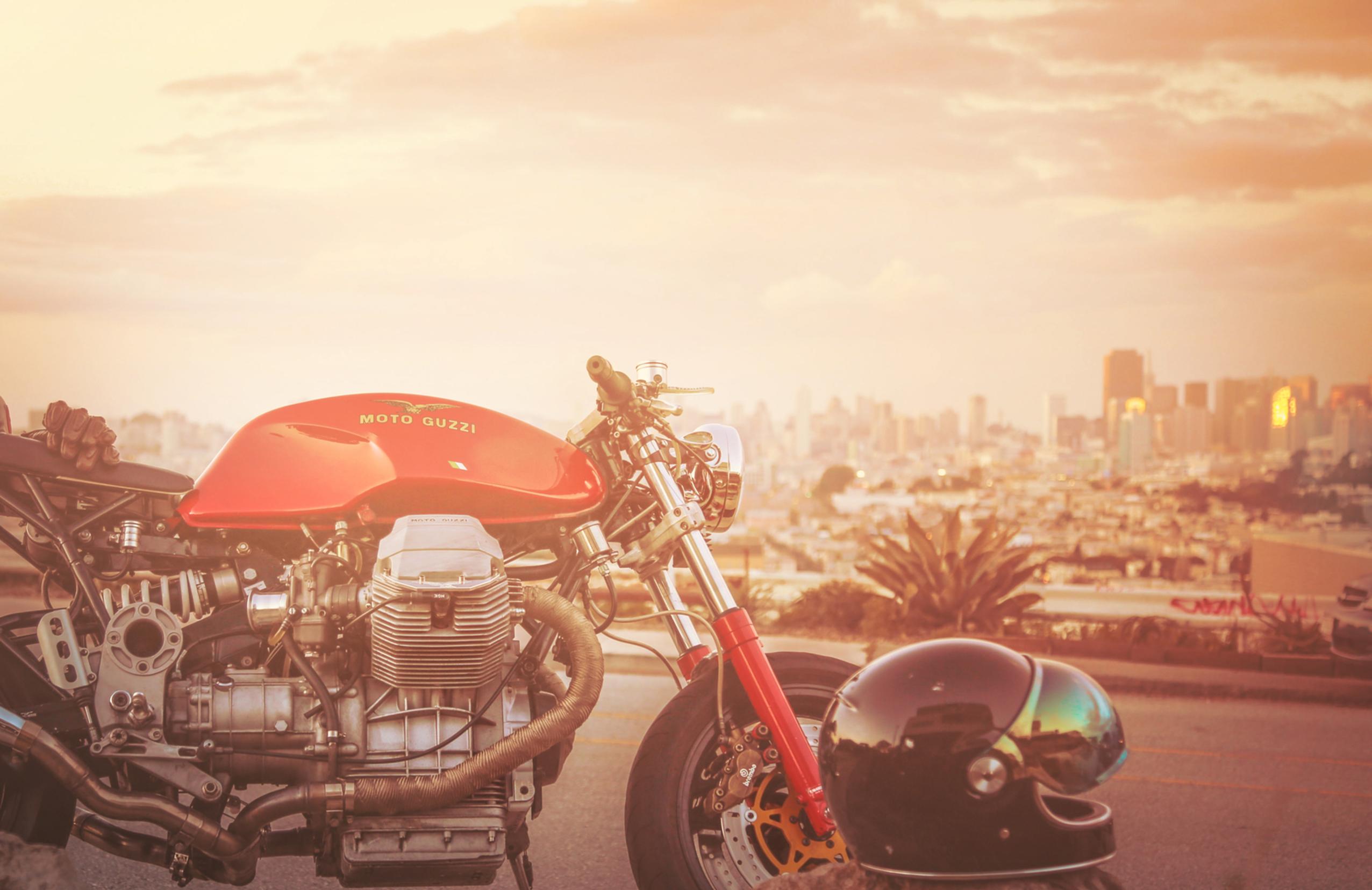 san francisco overview with cafe racer motorcycle and sunset