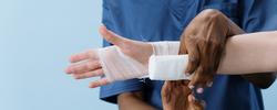 Nurse wrapping bandages around a patients hand