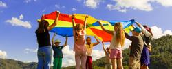 children playing outside with a parachute