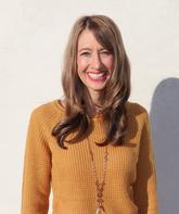 Lacey Horsman smiling in front of a wall