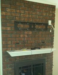 Flat screen tv mounted on brick fireplace wires installed through the brick, tv mounting service, flat screen tv mounting, charlotte nc