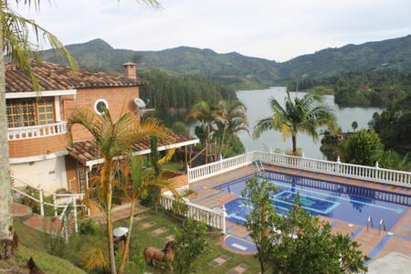 Guatape, Colombia, Spanish Villa facing a river crossing the mountains. Fitness retreats and Wellness Center