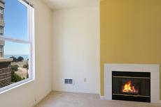 Living room with window view and fireplace
