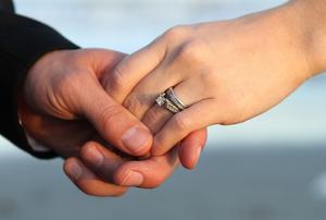 Couple's hands after elopement in Isle of Palms, SC