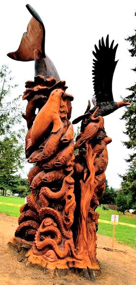 Massive stump carving totem. Wild life totem. Gig Harbor, WA totem at Crescent Creek Park, chainsaw carver in Washington state.
