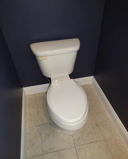 Newly painted bathroom walls dark blue.