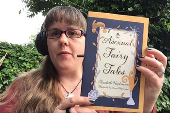 Elizabeth holds up the book