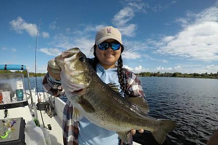 fisherman holding a fresh caught bass