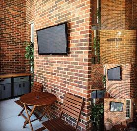 TV mounted to unwired brick wall on an outdoor patio, Carolina Custom mounts, Professional TV mounting service, Charlotte NC