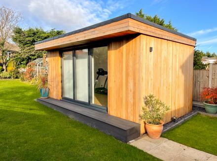Modern cedar clad garden room with 3 panel bifold doors