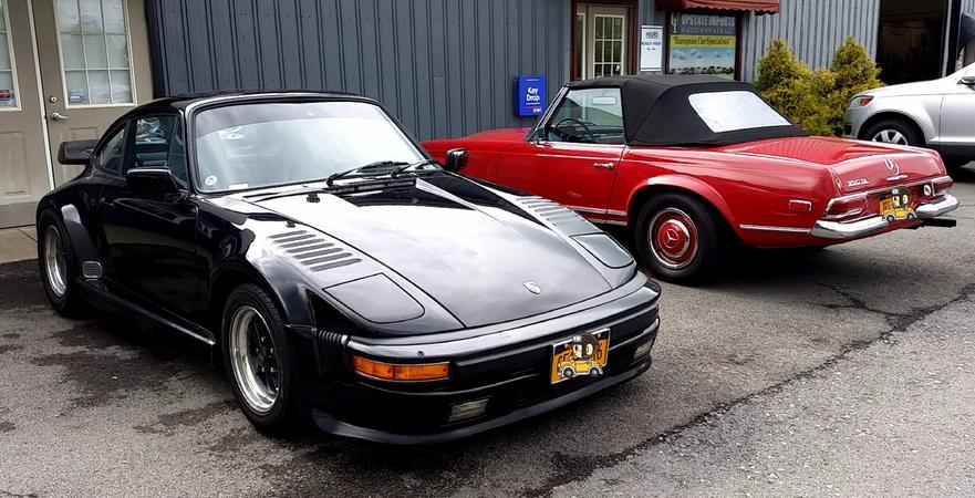 Two classic Porsche models in the parking lot of Upstate Imports