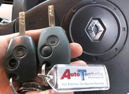 2 Renault van keys next to a Renault steering wheel