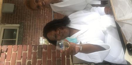 2 woman in bathrobes with a drink in hands
