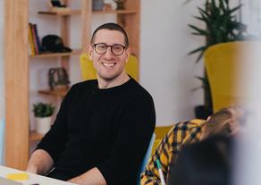 Man smiling at an office table