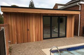 Modern cedar clad garden room pool house with bar, LED lighting, toilet and storage in Chelmsford, Essex built by Robertson Garden Rooms