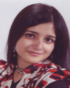 Masooma, head tilted toward left shoulder, subtle smile at camera.