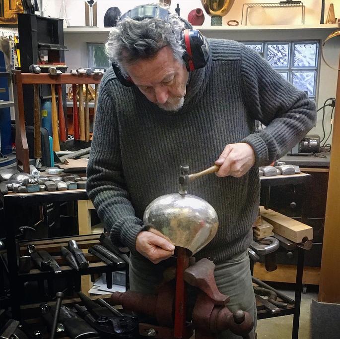 Metalsmith Kevin O'Dwyer plainishing a fine silver bowl.