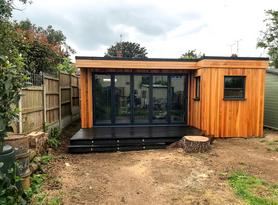 Modern cedar clad garden room with bar, office and 5 panel bifold doors in Southend, Essex built by Robertson Garden Rooms