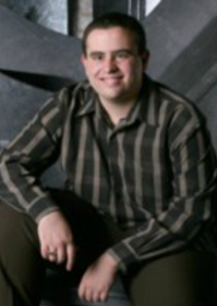 Jorge, sitting, smiling, looking at camera