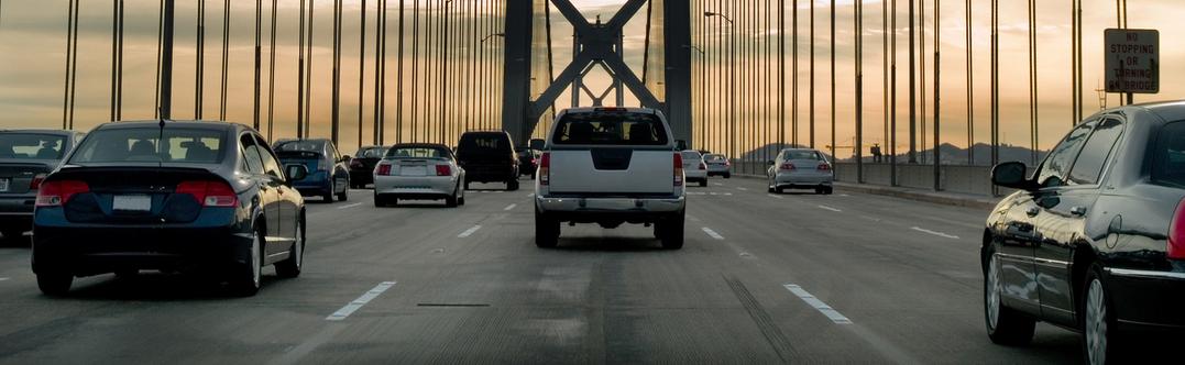 Cars driving cross country over a bridge