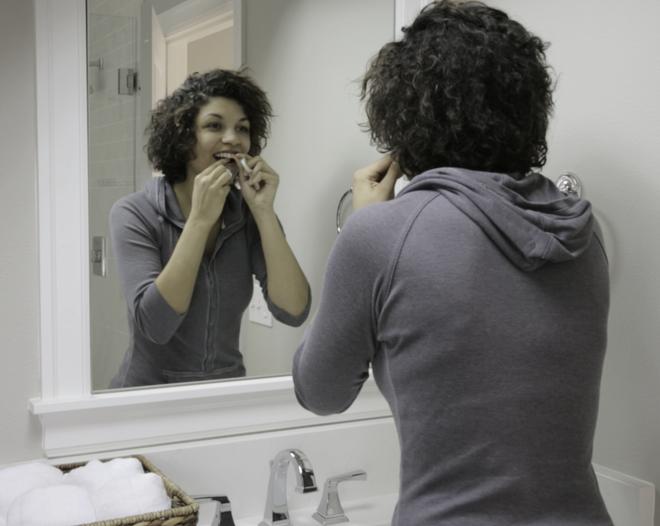 Zip Rings demonstrated by a model in front of a mirror