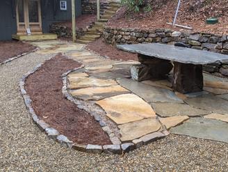 Rustic outdoor stone dining area installation in Rabun, GA