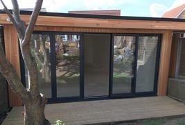 Modern cedar clad garden room with bifold doors, bar and pool table in Essex built by Robertson Garden Rooms