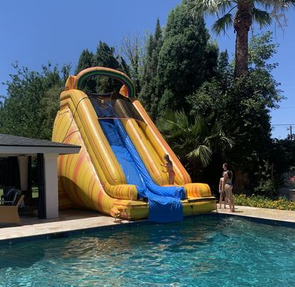 Blow up water store slide into pool