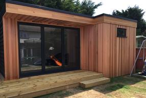 Modern cedar clad garden room with toilet, storage area and decking in Westcliff, Essex built by Robertson Garden Rooms