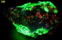 fluorescing WILLEMITE, HARDYSTONITE, CALCITE, FRANKLINITE - Franklin Mine, Franklin, Franklin Mining District, Sussex County, New Jersey, USA – Franklinite and Hardystonite type locality - for sale