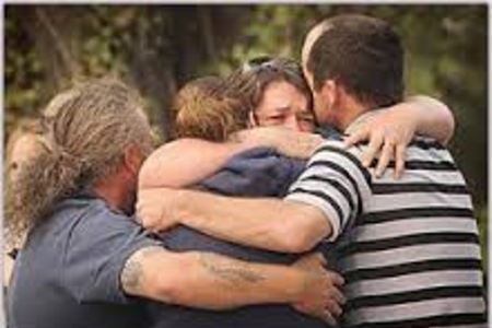 Grieving family embracing each other after discovering a death in a house in Tampa, FL.