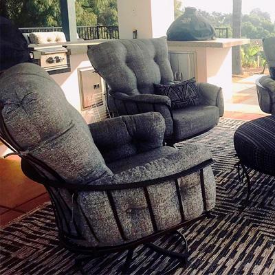 OW Lee Monterra chair in grey fabric with black ottoman sunbrella cushions