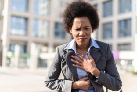 Young woman clutching her heart in pain