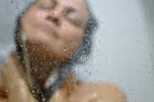 Woman enjoying a soft water shower.